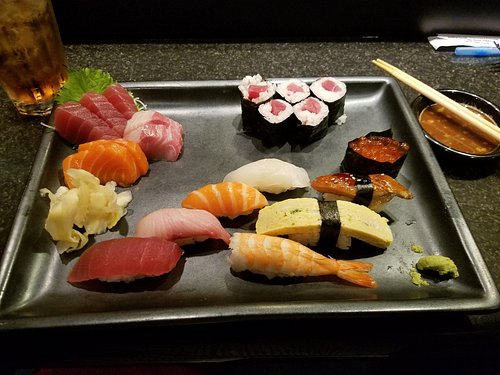 Jinbeh sushi platter featuring fresh nigiri and specialty rolls