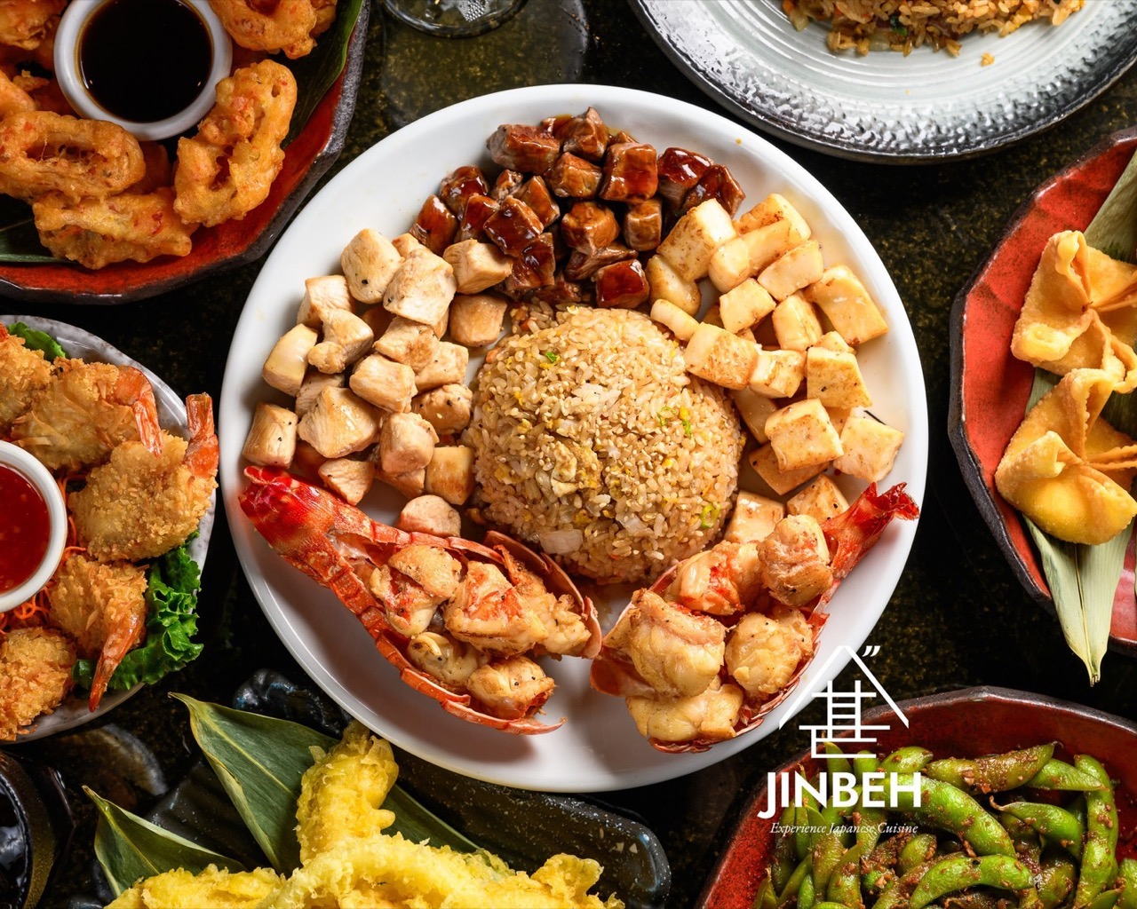 Lobster hibachi feast with chicken, steak, tofu, fried rice, tempura and edamame spread at Jinbeh Japanese Restaurant