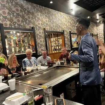 Group of friends enjoying hibachi dining experience at Jinbeh