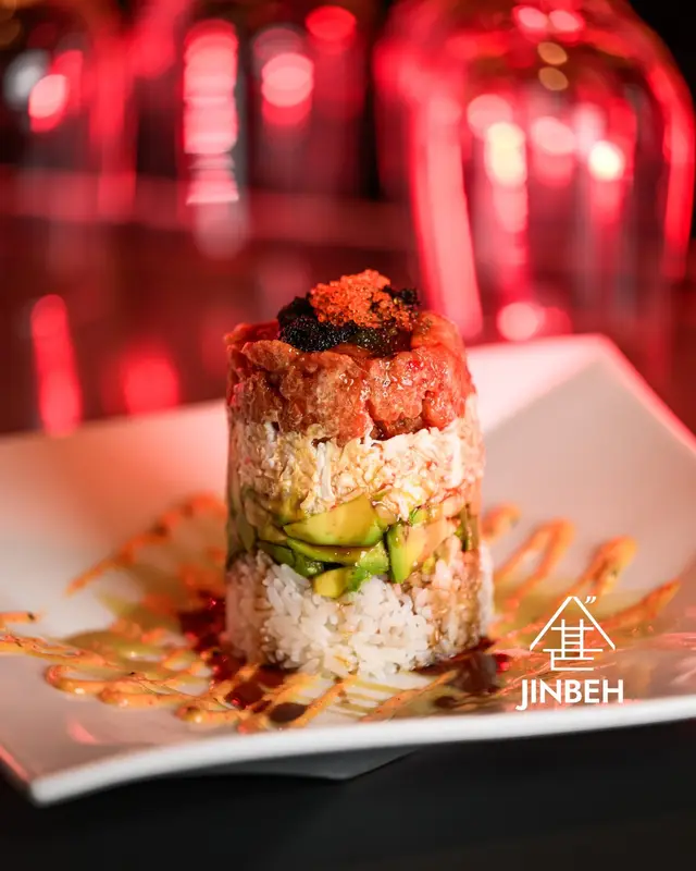 Spicy tuna tower with avocado, tobiko caviar, and sushi rice at the Jinbeh bar